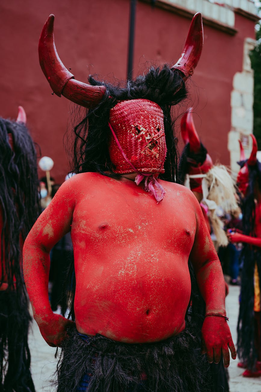 man dressed as devil during traditional festival