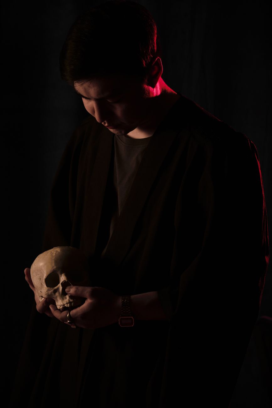 man holding a skull